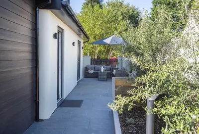a pathway leading to a house with an umbrella at Tiddlywink in Newquay