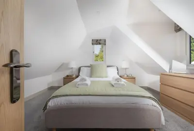 a bedroom with a bed with two towels on it at Tiddlywink in Newquay