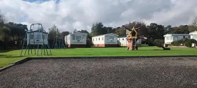a park with a playground with a slide at Peace Haven in Par