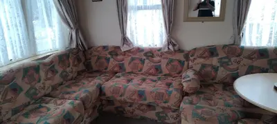 a couch in a living room with a blanket on it at Peace Haven in Par