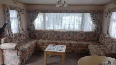 a living room with a couch and a table at Peace Haven in Par