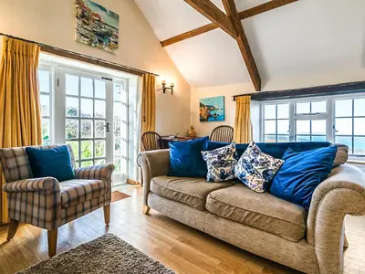 a living room with a couch and two chairs at Raddons - Uk50657 in Bude