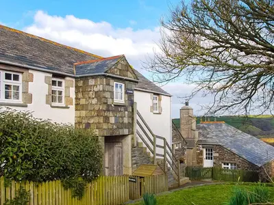 a white house with a wooden fence in front of it at Raddons - Uk50657 in Bude