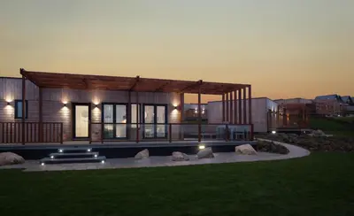 a modern house with lights on it at Landal Gwel an Mor in Portreath