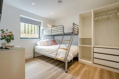 a small bedroom with bunk beds and a desk at 2 Bed in Tintagel oc-p33627 in Tintagel