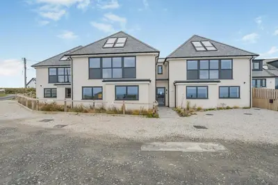 a large white house with a lot of windows at 2 Bed in Tintagel oc-p33627 in Tintagel