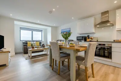 a kitchen and living room with a table and chairs at 2 Bed in Tintagel oc-p33627 in Tintagel