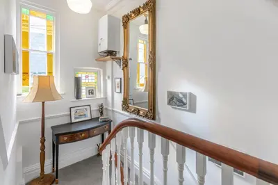a stairway with a mirror and a table at 4 Bed in St. Ives oc-t33609 in St Ives