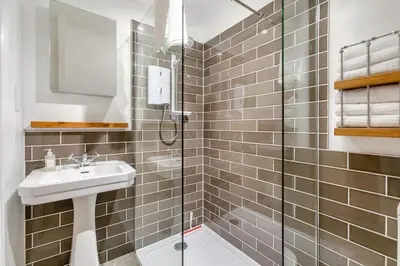 a bathroom with a sink and a shower at 4 Bed in St. Ives oc-t33609 in St Ives