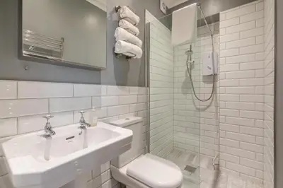a bathroom with a toilet and a sink and a shower at 4 Bed in St. Ives oc-t33609 in St Ives