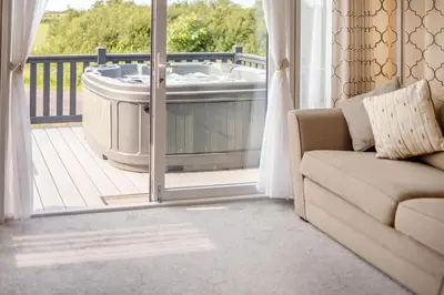 a living room with a tub on a balcony at 2 Bed in Hendra Croft oc-h32360 in Cubert