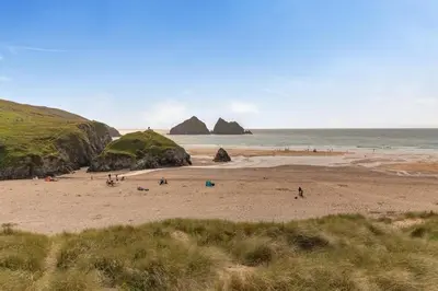 a group of people on a beach near the ocean at 2 Bed in Hendra Croft oc-h32360 in Cubert