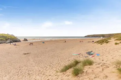 a beach with a group of people on the sand at 2 Bed in Hendra Croft oc-h32360 in Cubert