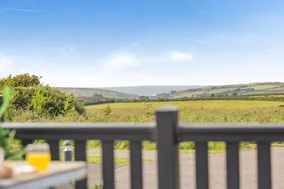 a view from the balcony of a house with a view of a field at 2 Bed in Hendra Croft oc-h32360 in Cubert