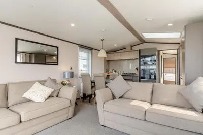 a living room with two couches and a kitchen at 2 Bed in Hendra Croft oc-h32360 in Cubert
