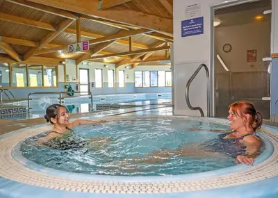 two women in a hot tub in a swimming pool at Praa Sands Holiday Park in Praa Sands