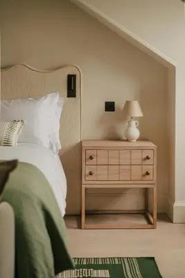 a bedroom with a bed and a nightstand with a lamp at Seaside Cottage in St Ives in St Ives