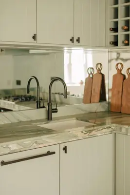 a kitchen with a sink and two faucets at Seaside Cottage in St Ives in St Ives