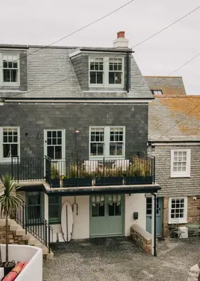 a house with a green door and a balcony at Seaside Cottage in St Ives in St Ives