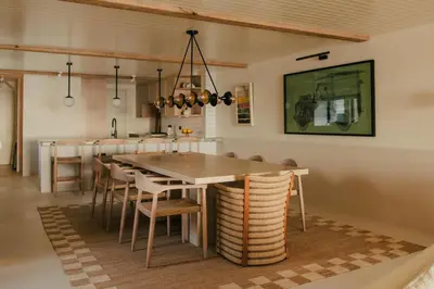 a dining room and kitchen with a table and chairs at Beachfront Apartment in St Ives in St Ives