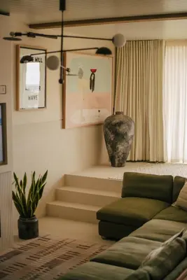a living room with a couch and some stairs at Beachfront Apartment in St Ives in St Ives
