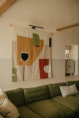 a living room with a couch and a painting on the wall at Beachfront Apartment in St Ives in St Ives