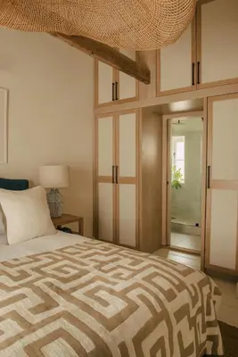 a bedroom with a large bed and a glass door at Cozy Cottage in St Ives in St Ives