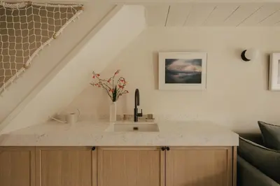 a kitchen with a sink and a staircase at Cozy Cottage in St Ives in St Ives
