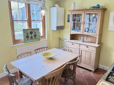 a kitchen with a wooden table and some chairs at Seabreeze in St Ives