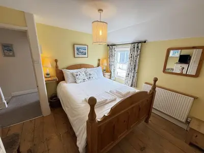 a bedroom with a large bed in a room at Seabreeze in St Ives