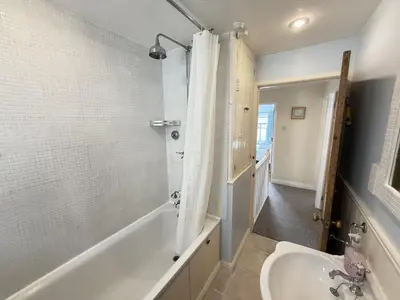 a bathroom with a bath tub and a sink at Seabreeze in St Ives