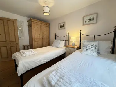 two twin beds in a room with twoermottermott at Seabreeze in St Ives