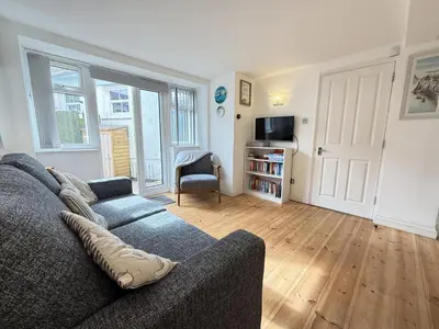 a living room with a couch and a television at Pennys Place in St Ives
