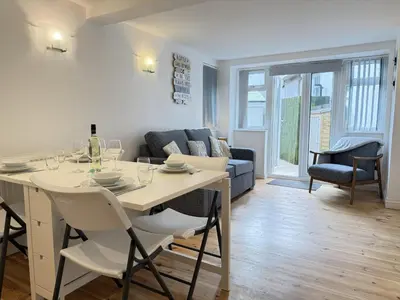 a living room with a table and a couch at Pennys Place in St Ives