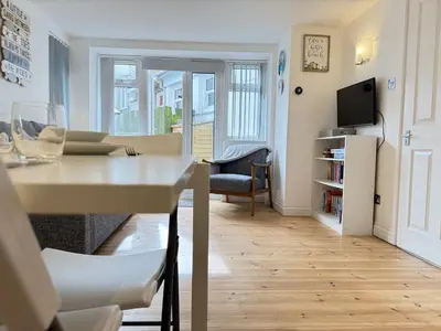 a living room with a dining table and a living room at Pennys Place in St Ives