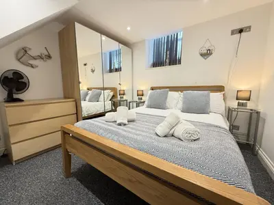 a bedroom with a large bed with towels on it at Pennys Place in St Ives
