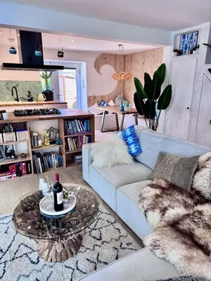 a living room with a couch and a table at Boho Bali-style Beach House near Fistral in Newquay