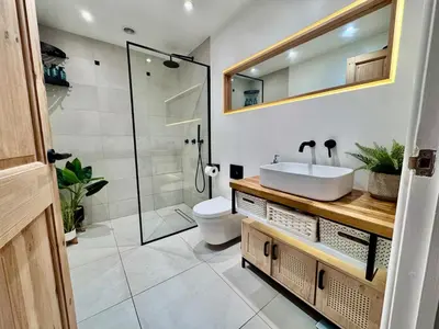 a bathroom with a toilet and a sink and a shower at Boho Bali-style Beach House near Fistral in Newquay