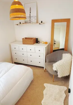 a bedroom with a bed and a chair and a mirror at Entire Apartment in Pretty Coastal Village in Cubert