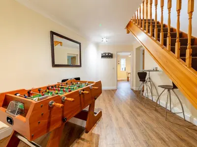 a room with a foosball table and stairs at Holiday Home Porthilly by Interhome in Mevagissey