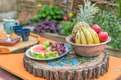 a bowl of fruit on a table with a plate of fruit at 1 Bed in Menheniot oc-t29268 in Menheniot