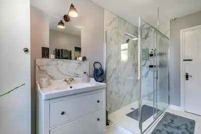 a white bathroom with a sink and a shower at 1 Bed in Menheniot oc-t29268 in Menheniot