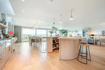 a kitchen with a large island in the middle of a room at 5 Bed in Polzeath oc-r33648 in Polzeath