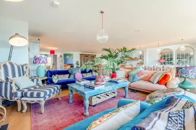 a living room with blue couches and a table at 5 Bed in Polzeath oc-r33648 in Polzeath