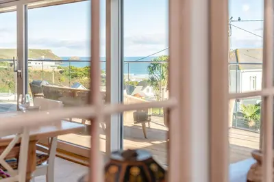 a room with a view of the ocean from a window at 5 Bed in Polzeath oc-r33648 in Polzeath