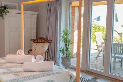a bedroom with a bed and a balcony with a patio at 5 Bed in Polzeath oc-r33648 in Polzeath