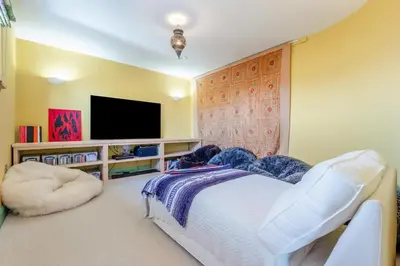 a bedroom with a white bed and a tv at 5 Bed in Polzeath oc-r33648 in Polzeath