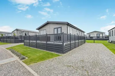 a house with a fence around a yard at 3 Bed in Padstow oc-l33613 in Padstow