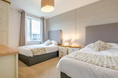 a bedroom with two beds and a window at 3 Bed in Padstow oc-l33613 in Padstow