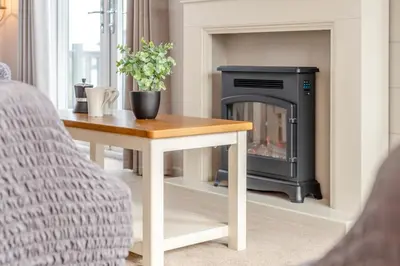a living room with a wood stove in a fireplace at 3 Bed in Padstow oc-l33613 in Padstow